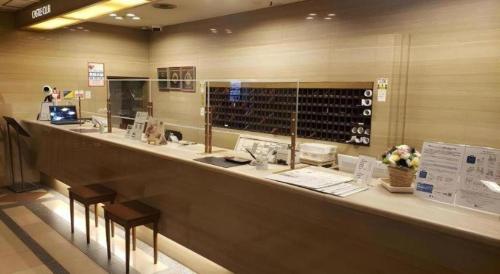 a counter in a wine shop with two stools at Hotel Castle Plaza in Kobe