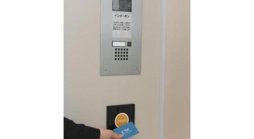 a person holding up a blue star in front of a parking meter at KEIKYU EX INN Keikyu Kawasaki-Station in Kawasaki