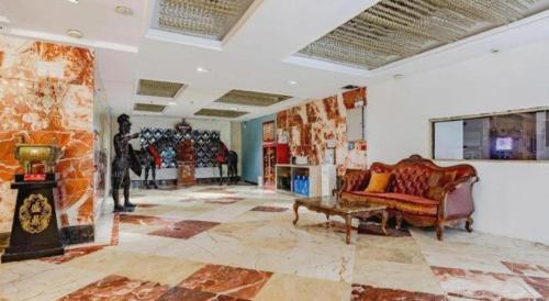 a living room with a couch and a fireplace at GreenTree Alliance Anhui Hefei South Passenger Station South High Speed Railway Station Hotel in Hefei
