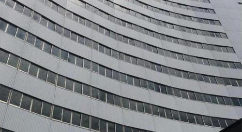 a tall building with many windows on the side of it at Hotel Harvest Nankitanabe in Tanabe