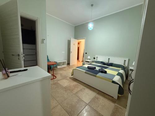 a bedroom with a large bed and a bathroom at La casetta di Fra & Giù in Longobucco