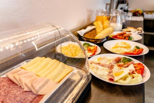 a buffet with plates of food on a table at Apartmány Zaria in Bešeňová