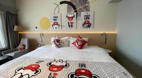 a bed with hello kitty decorations on it in a room at Imin Hotel in Huadu
