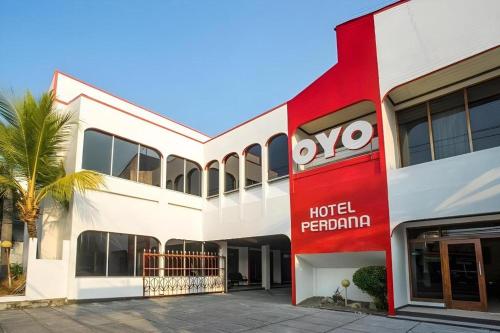 a red and white building with a hotel peroni at Super OYO 1046 Omah Pathok in Yogyakarta
