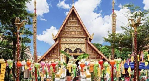a building with a bunch of colorful umbrellas in front of it at Nantawan Hotel in Chiang Rai