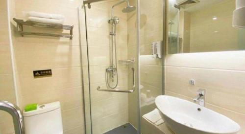 a bathroom with a shower and a sink and a toilet at 7 Days Premium Hotel Ji'an Taihe Gongnongbing Avenue in Ji'an