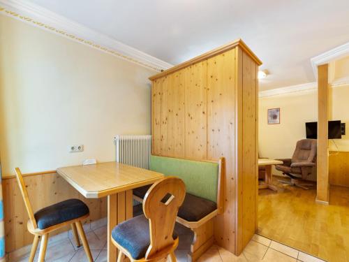 a room with a desk and a table and chairs at Apartment in Saalbach-Hinterglemm near Ski Area in Saalbach Hinterglemm