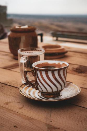 a cup of coffee on a plate on a table at Kampanario Luxury Two-Bedroom Villa with Private Jacuzzi in Megalokhori