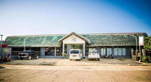 a building with cars parked in front of it at Sabine's Place in Masbate