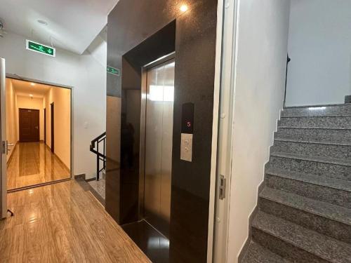 a hallway with a door leading to a stair case at Motel Phuong Linh in Da Nang
