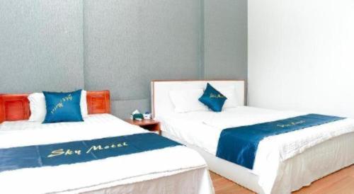 two beds sitting next to each other in a room at SKY HOTEL - KHÁCH SẠN BẮC NINH in Bắc Ninh