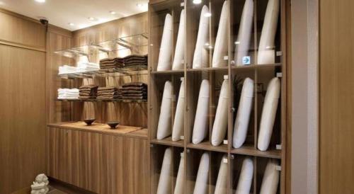 a closet filled with white baseball bats in it at Hotel Sunoak Kashiwanoha in Kashiwa