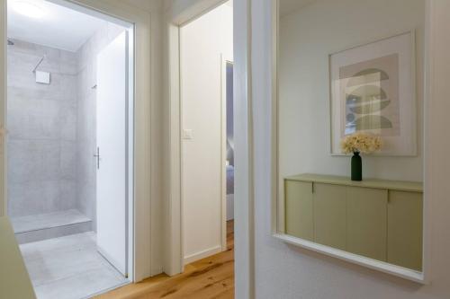 a bathroom with a mirror and a walk in shower at Vertical Suite in Zürich