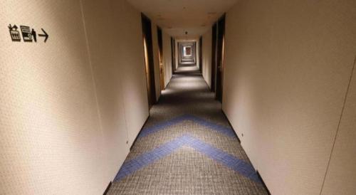 a hallway with a blue star painted on the floor at KEIKYU EX INN Haneda Innovation City 2 minutes walk from HICity Exit of Tenkubashi Station in Tokyo