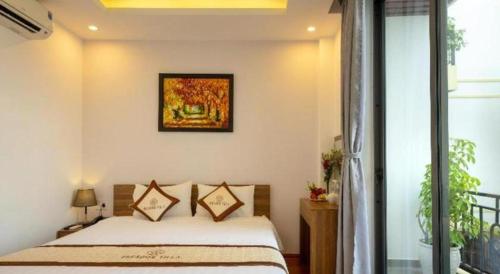 Postel nebo postele na pokoji v ubytování Hoi An Paradise Villa