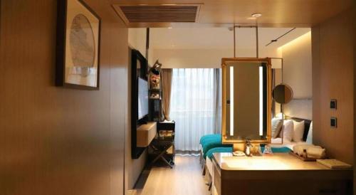a bathroom with a sink and a mirror at Ethos Hotel Wuhan Riverside in Wuhan