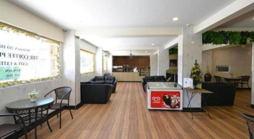 a lobby with couches and chairs and a waiting room at Station 203 Hotel in Bangkok