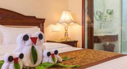 two stuffed birds sitting on a bed in a hotel room at Quanzhou Hotel in Quanzhou