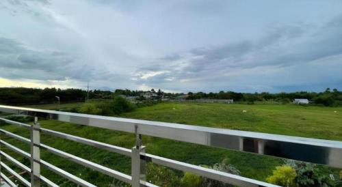 a view of a field with a fence at Pilot Hotel in Alaminos