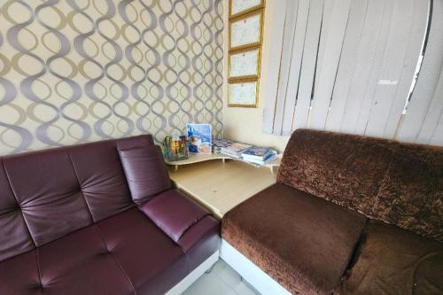 a living room with a couch and a table at ONE Residence in Pathum Thani