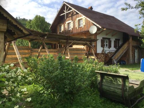 a large wooden house with a wooden pergola at Salamandra Village in Kozevo