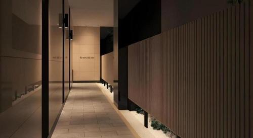 a hallway in a building with lights on the walls at KEIKYU EX INN Tokyo Nihombashi in Tokyo