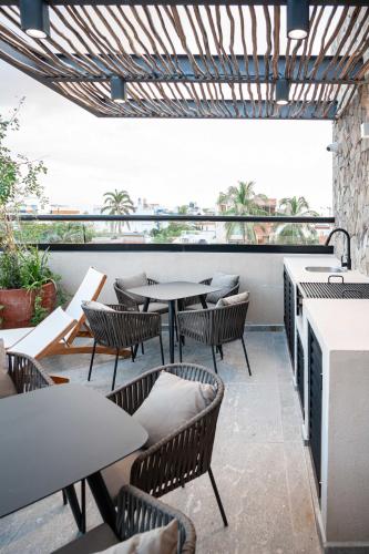 a restaurant with tables and chairs on a patio at Romantic Getaway Suite w-Private Terrace in Bucerías