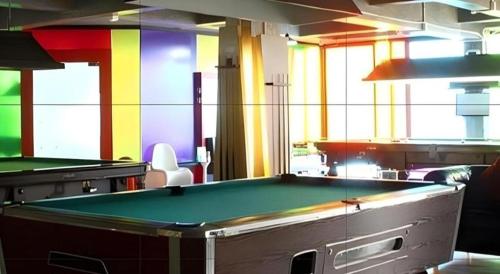 a pool table in a room with colorful walls at The B Ranong Trend Hotel in Ranong