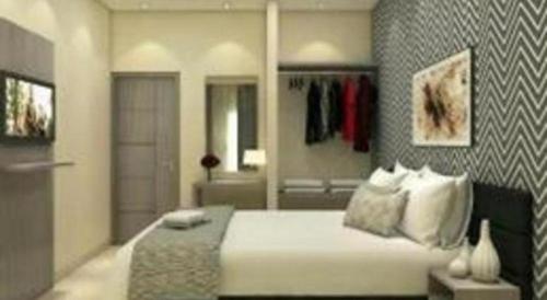 a bedroom with a large bed and a bathroom at Smart Budget Hotel in Semarang