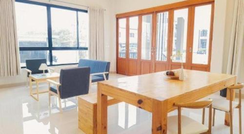 a living room with a wooden table and chairs at Triple B sleep and relax in Nakhon Ratchasima