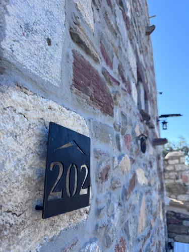 a sign on the side of a brick wall at Castle Rizaraki in Kokkala