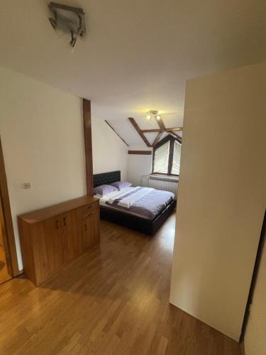 a bedroom with a bed in a room with a window at Luxury house in heart of Old town Bascarsija in Sarajevo