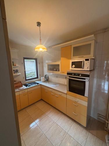 a kitchen with a microwave oven and a stove at Luxury house in heart of Old town Bascarsija in Sarajevo