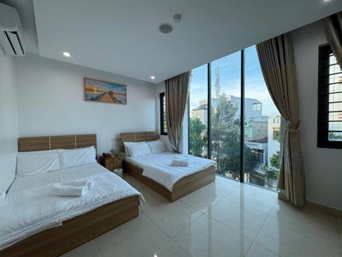 Ένα ή περισσότερα κρεβάτια σε δωμάτιο στο Ruby Star Hotel - Apartment Biển Vũng Tàu