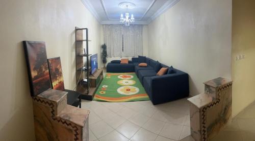 a living room with a blue couch and a table at Perfect stay in Agadir
