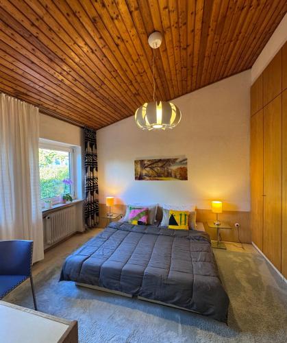 a bedroom with a large bed and a wooden ceiling at Zwei Zimmer im Reihenhaus in Niederdorla