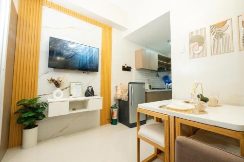 a kitchen with a table and a kitchen with a sink at Modern Retreat with Private Balcony in Mactan Island