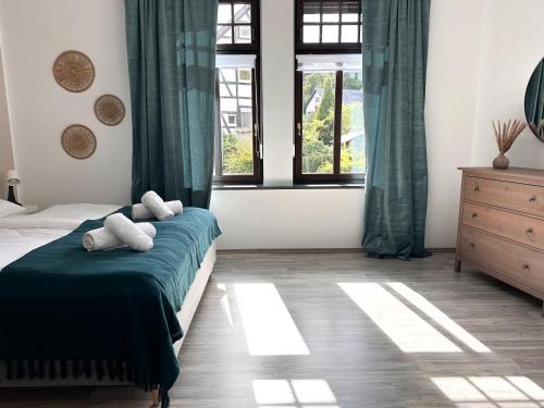 a bedroom with a bed with two stuffed animals on it at Beautiful Apartment Köln 15 Min to Phantasialand in Hürth