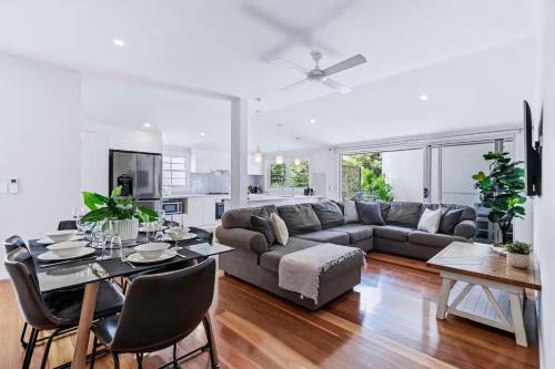 a living room with a couch and a table at Park Avenue Terrace House 3BR - Outdoor, BBQ in Brisbane