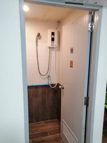a shower stall in a bathroom with a door at KS RESIDENCE Victory Monument in Bangkok