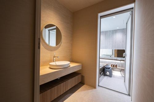 a bathroom with a sink and a mirror at Vast Bleu IWAYA in Awaji