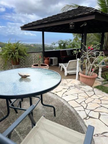 a table with a bird sitting on it on a patio at Fare Bungalow in Papeete
