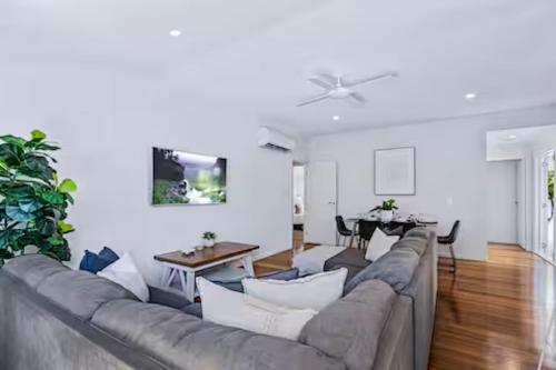 a living room with a couch and a table at Park Avenue Terrace House 3BR - Outdoor, BBQ in Brisbane