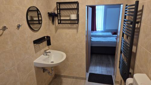 a small bathroom with a sink and a toilet at Pension STELLA in Lutherstadt Eisleben