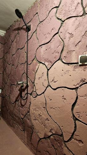 a brick wall with a shower in a room at Château Berbère Madame DELLAL in Taroudant