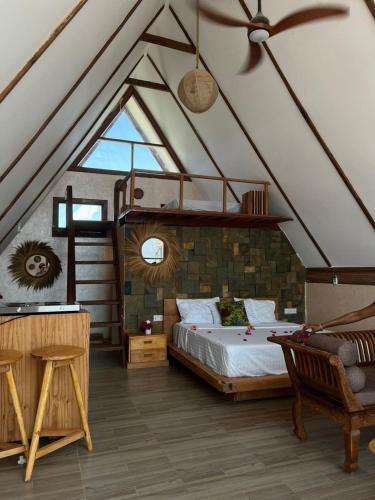 a bedroom with a bed and a loft at Solo-A-Villa in Paje