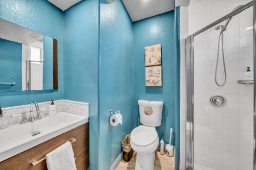 a bathroom with a toilet and a sink and a shower at @ Marbella Lane - 4BR Near Morongo Casino & Outlet Ldry+P in Banning