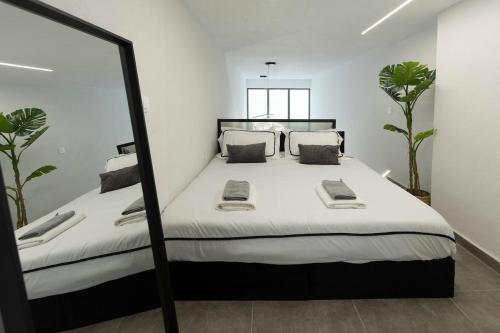 a bedroom with a large bed and a mirror at myloft luxury stay in Edessa
