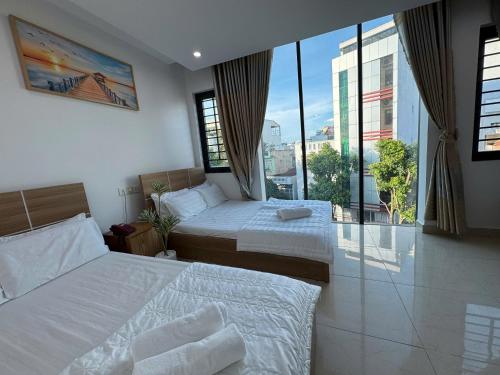 Ένα ή περισσότερα κρεβάτια σε δωμάτιο στο Ruby Star Hotel - Apartment Biển Vũng Tàu