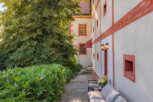 a walkway with benches next to a building at Zámek Ostrolov in Ostrolovský Újezd